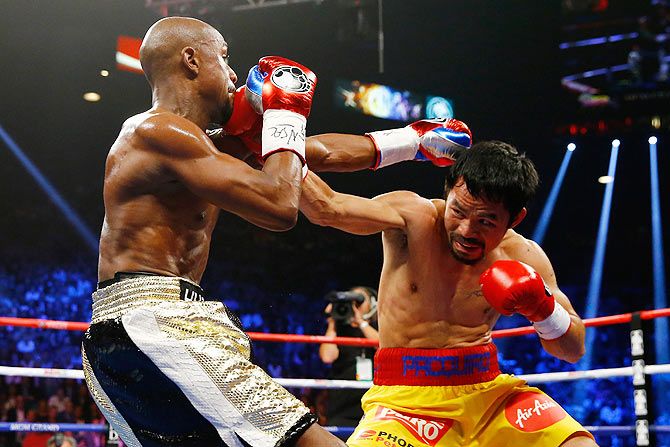 Floyd Mayweather Jr. and Manny Pacquiao exchange punches