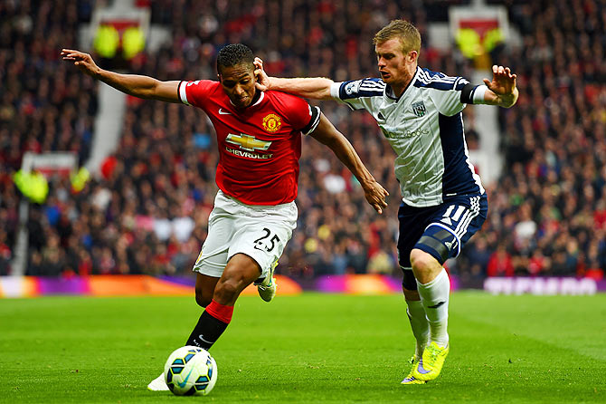 Luis Antonio Valencia of Manchester United battles for the ball with Chris Brunt of West Brom