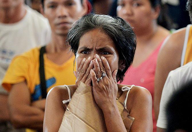 A woman reacts while watching the fight of Manny Pacquiao of the Philippines and Floyd Mayweather of US on a live telecast monitor inside a gym in Manila on Sunday