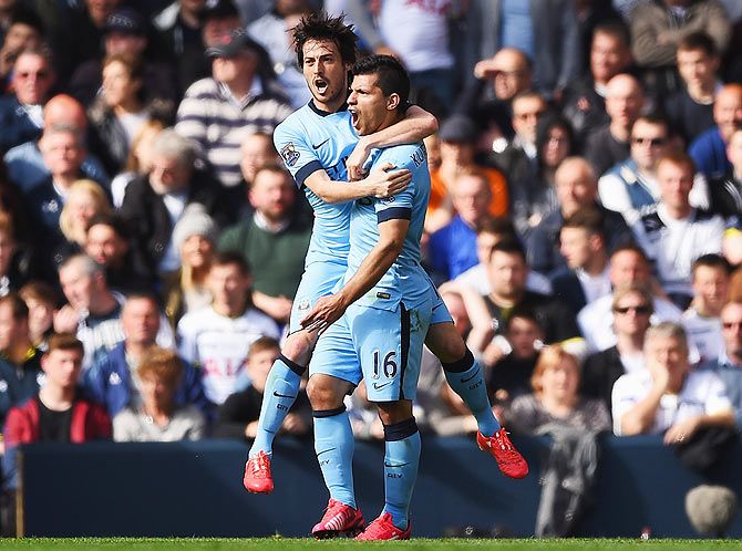 Manchester City's Sergio Aguero celebrates with teammate David Silva after scoring the opening goal against Tottenham Hotspur during their English Premier League match at White Hart Lane in London on Sunday