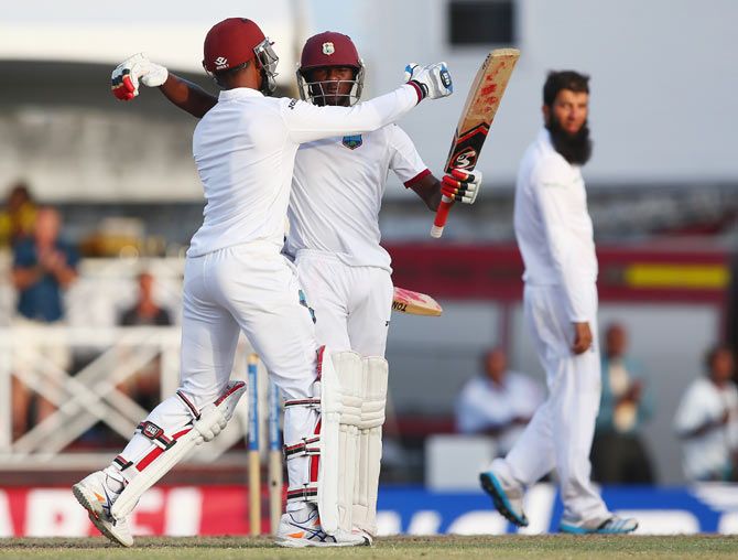 Jermaine Blackwood (right) and Denesh Ramdin of West Indies celebrate victory and drawing the series 1-1 on Day 3 of the 3rd Test against England at Kensington Oval in Bridgetown, Barbados, on Sunday