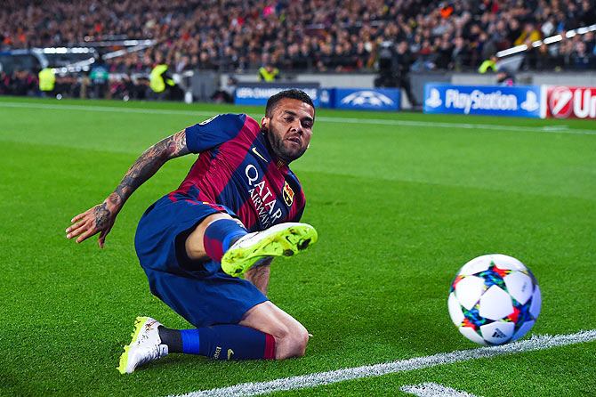 FC Barcelona Dani Alves slides as he attempts to keep the ball in play