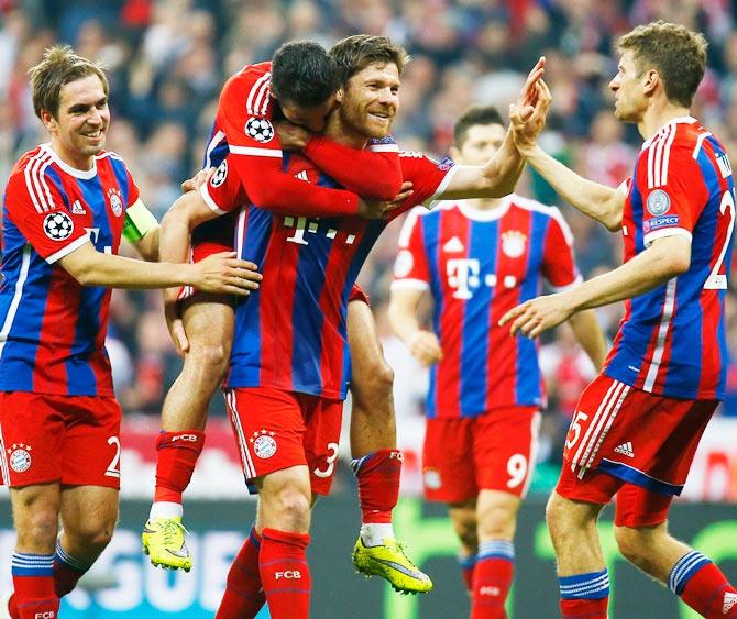 Bayern Munich's Xabi Alonso celebrates scoring their sixth goal with teammates Thiago Alcantara, Philipp Lahm (left) and Thomas Muller (right)