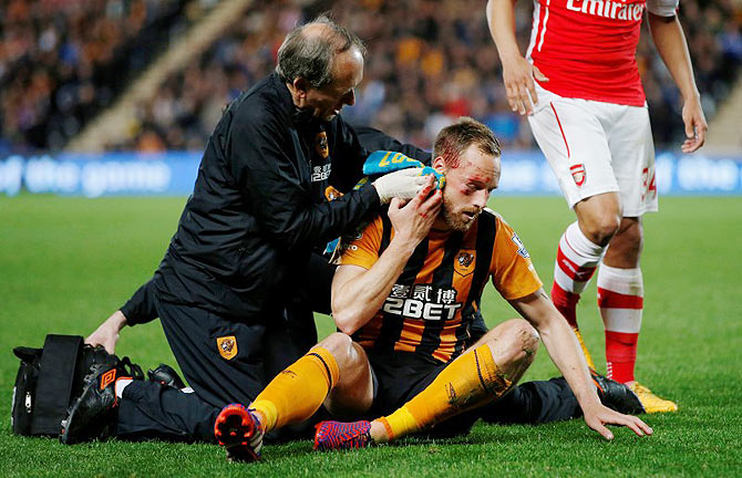 Hull City's David Meyler receives treatment after sustaining a facial injury 