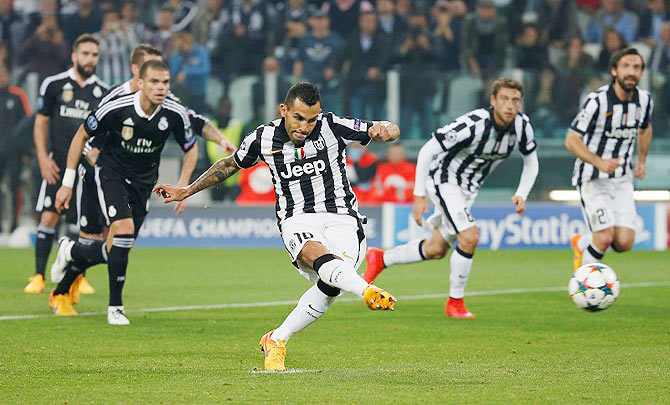 Juventus' Carlos Tevez scores their second goal from the penalty spot