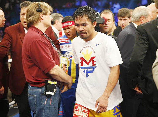 Manny Pacquiao of the Philippines leaves the ring after losing to Floyd Mayweather, Jr. of the US on Saturday