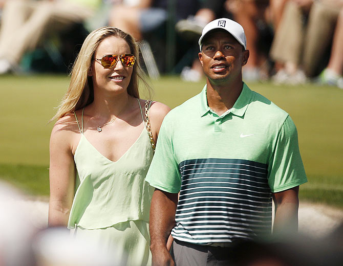 Skier Lindsey Vonn stands next to US golfer Tiger Woods