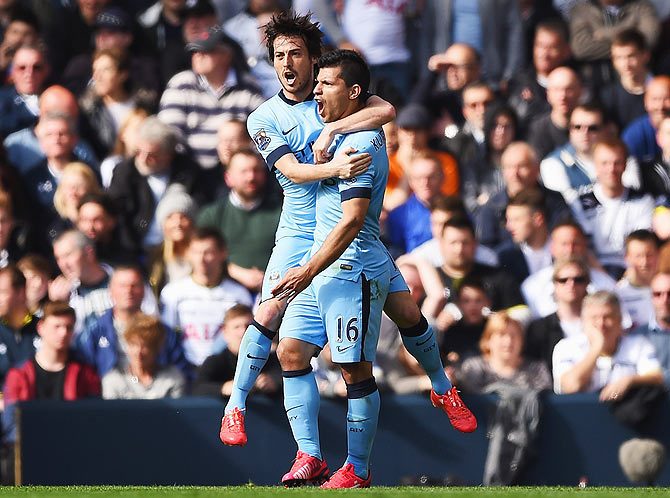 Manchester City's Sergio Aguero celebrates with teammate David Silva 