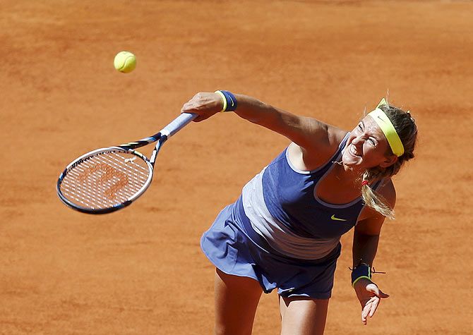 Victoria Azarenka of Belarus serves the ball to Serena Williams of the US during their match at the Madrid Open tennis tournament on Wednesday