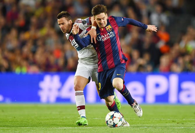 Barcelona's Lionel Messi and Bayern Muenchen's Juan Bernat battle for possession during their UEFA Champions League semi-final, first leg match at Camp Nou in Barcelona Wednesday