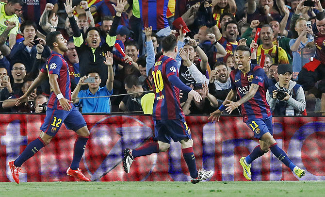 Barcelona's Neymar celebrates scoring their third goal with Lionel Messi and Dani Alves