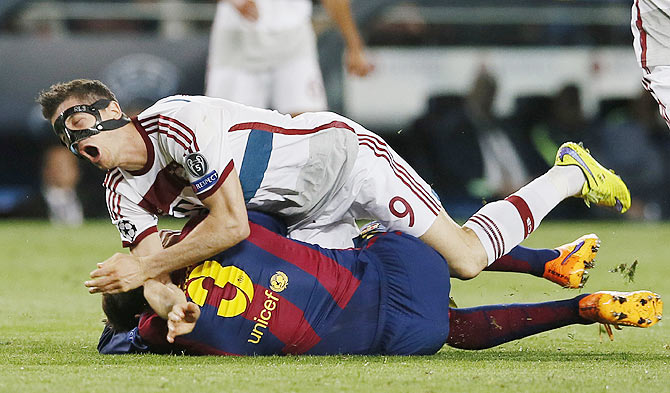 Barcelona's Gerard Pique in action with Bayern Munich's Robert Lewandowski