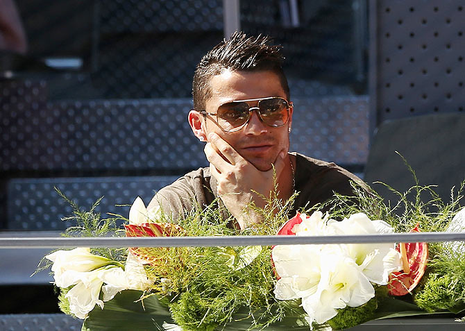 Cristiano Ronaldo of Real Madrid watches Spain's Rafael Nadal in action against Italian Simone Bolelli