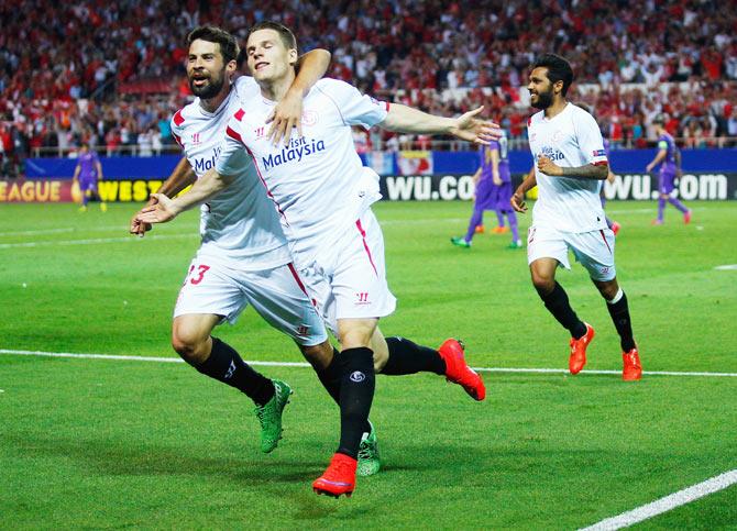 Kevin Gameiro of Sevilla celebrates scoring his team's third goal with teammate Coke during their UEFA Europa League first leg semi-final against ACF Fiorentina at Estadio Ramon Sanchez Pizjuan in Seville on Thursday