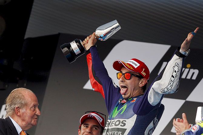 Yamaha MotoGP rider Jorge Lorenzo of Spain celebrates on the podium next to former King of Spain Juan Carlos (left) after winning the Spanish Grand Prix in Jerez de la Frontera, southern Spain, on May 3