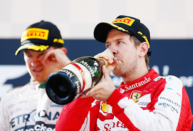 Sebastian Vettel of Germany and Ferrari celebrates on the podium after finishing third in the Spanish Formula One Grand Prix