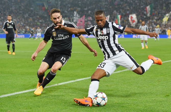 Juventus' Patrice Evra is challenged by Real Madrid's Daniel Carvajal during their UEFA Champions League semi-final first leg match at Juventus Arena in Turin