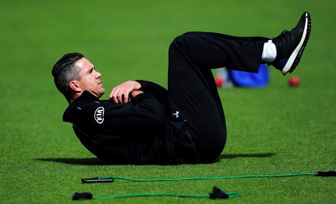 Kevin Pietersen of Surrey warms up prior to the start of play