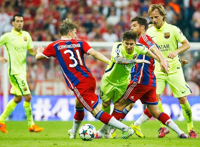Barcelona's Lionel Messi and Ivan Rakitic in action with Bayern Munich's Bastian Schweinsteiger and Xabi Alonso