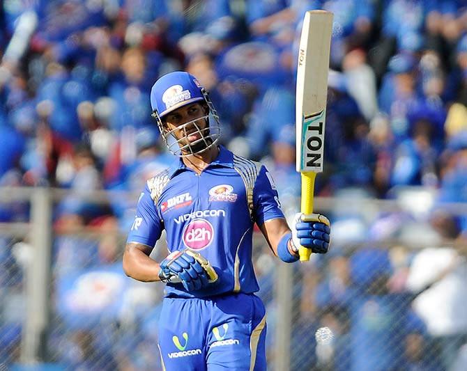 Lendl Simmons of Mumbai Indians raises his bat after scoring a half century