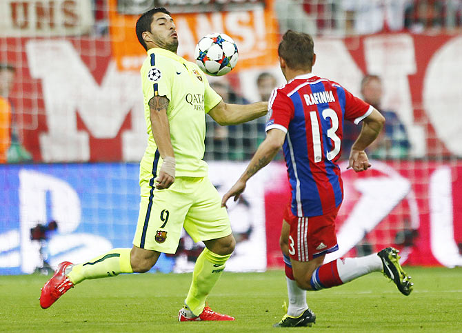 Barcelona's Luis Suarez in action with Bayern Munich's Rafinha