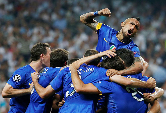  Juventus' Alvaro Morata celebrates after scoring their first goal with Arturo Vidal and teammates during their UEFA Champions League semi-final second leg match at Estadio Santiago Bernabeu, in Madrid on Wednesday.