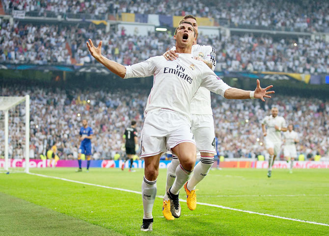 Cristiano Ronaldo of Real Madrid celebrates with teammate Sergio Ramos of Real Madrid after scoring the opening goal from the penalty spot 