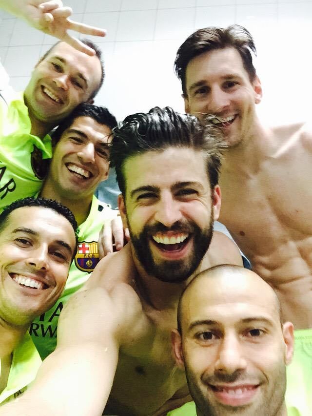 Barcelona's Gerard Pique celebrates with teammates in the dressing room