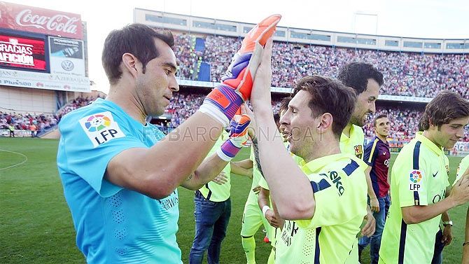 Barcelona goalkeeper Claudio Bravo celebrates with Lionel Messi