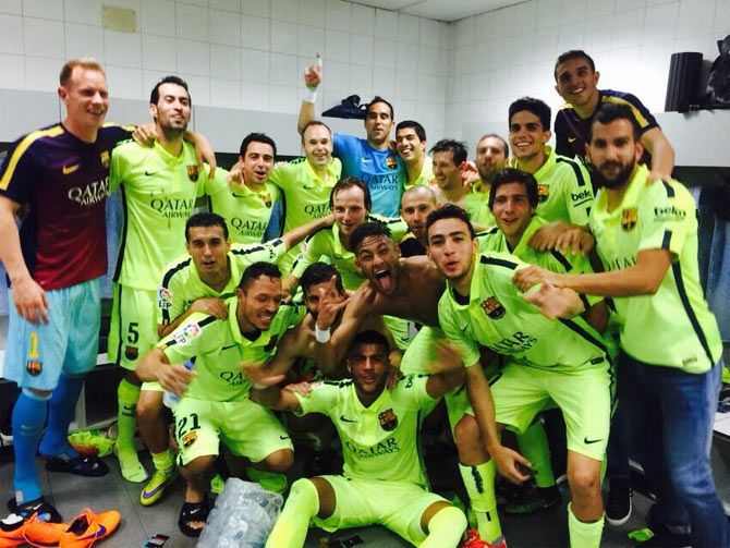 Barcelona players celebrate in the dressing room
