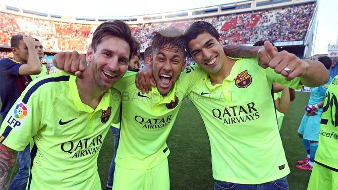 Barcelona's star forward line-up Lionel Messi, Neymar and Luis Suarez celebrate on the pitch after their win on Sunday