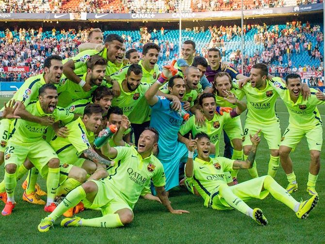 Barcelona players celebrate winning the title after the La Liga match against Club Atletico de Madrid