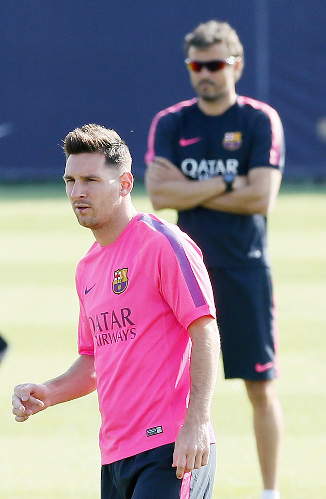 FC Barcelona's coach Luis Enrique (right) and Lionel Messi take part in a training session