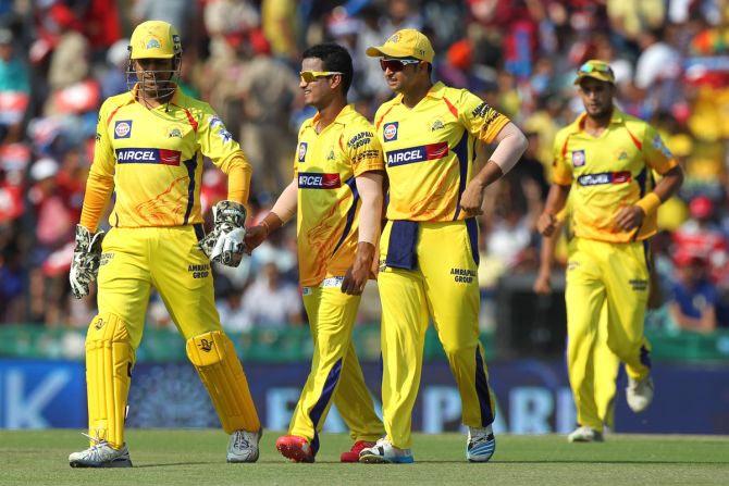 Chennai Super Kings' Pawan Negi celebrates with captain Mahendra Singh after picking up a wicket