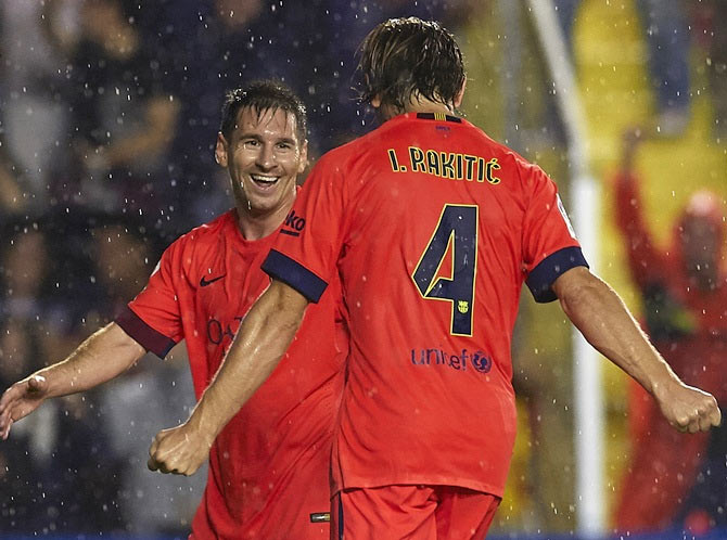 Ivan Rakitic of Barcelona celebrates scoring with his teammate Lionel Messi during the La Liga match against Levante UD
