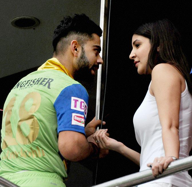 Royal Challengers Bangalore captain Virat Kohli chats with his girlfriend, Anushka Sharma in the VIP Box