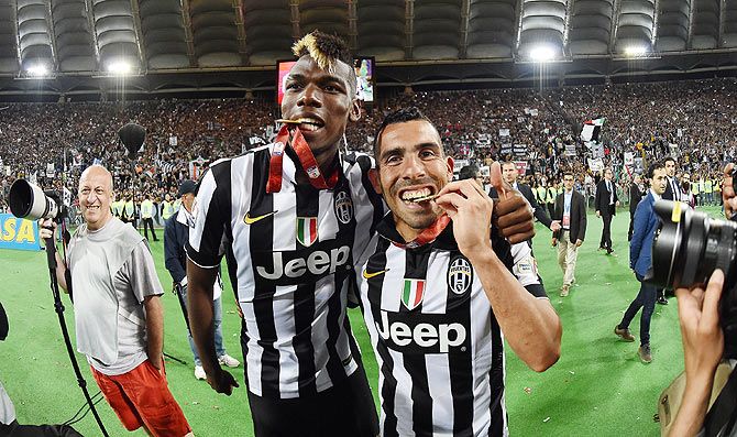 Paul Pogba and Carlos Tevez of Juventus celebrate victory