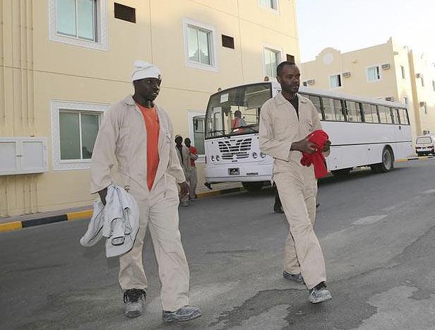 Labourers working on the Qatar 2022 World Cup project, arrive at their accommodation in Doha on March 3, 2014.