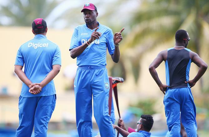  Curtly Ambrose (centre) the bowling coach of West Indies speaks to players during a nets session