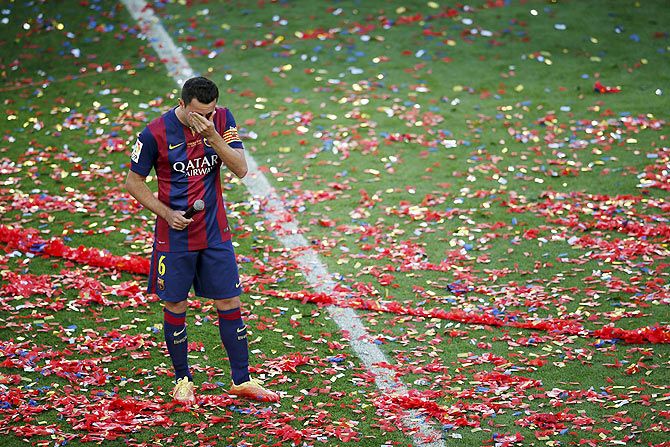 Barcelona's captain Xavi Hernandez cries during his tribute at Camp Nou stadium in Barcelona on Saturday