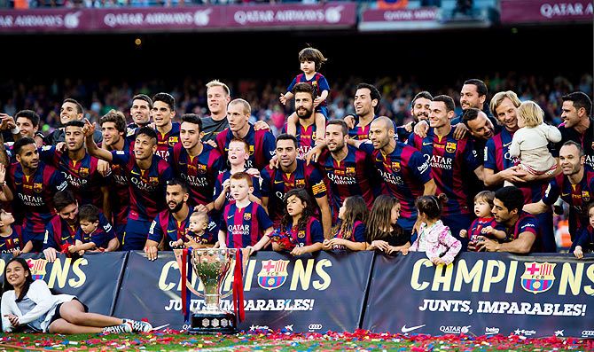 FC Barcelona players and their families celebrate with the La Liga trophy