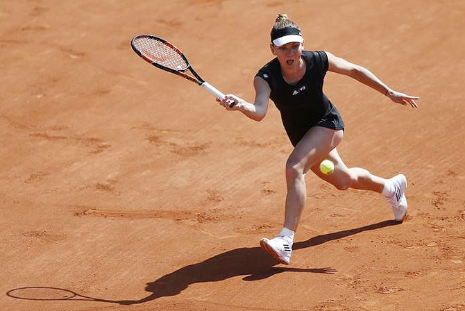 Romanian Simona Halep plays a shot against Russia's Evgeniya Rodina during their first round women's singles match at the French Open tennis tournament at the Roland Garros stadium in Paris on Sunday