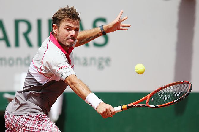 Stanislas Wawrinka of Switzerland plays a backhand against Marsel Ilhan of Turkey