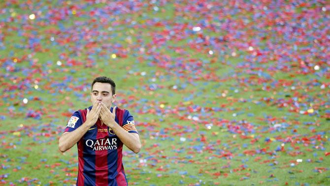 Barcelona's captain Xavi Hernandez blows kisses to the crowd during his tribute at Camp Nou stadium in Barcelona on Saturday following their match against Deportivo La Coruna that ended in a 2-2 draw. Xavi announced on Thursday his retirement from Barcelona at the end of the current season. He will play next season at Al Sadd in Qatar