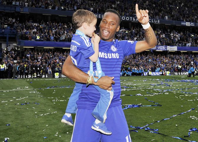 Chelsea's Didier Drogba celebrates with a teammates child