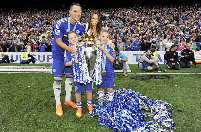 Chelsea's John Terry and his family pose with the trophy