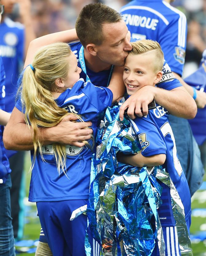 Chelsea's John Terry kisses his children as they celebrate winning the Premier League title