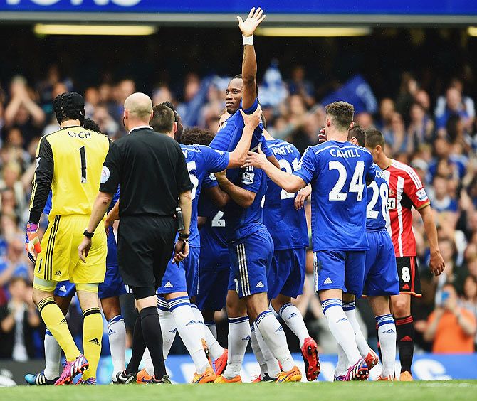 Didier Drogba of Chelsea is lifted by his teammates as he is substituted