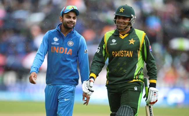 India's Virat Kohli with Misbah-ul Haq of Pakistan