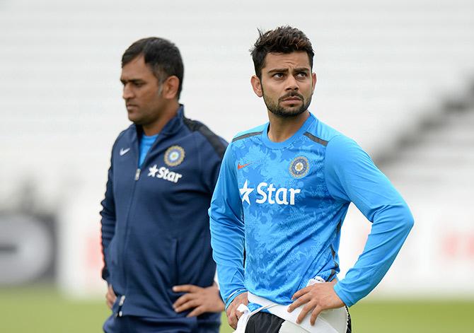 Mahendra Singh Dhoni (L) and Virat Kohli attend a training session 